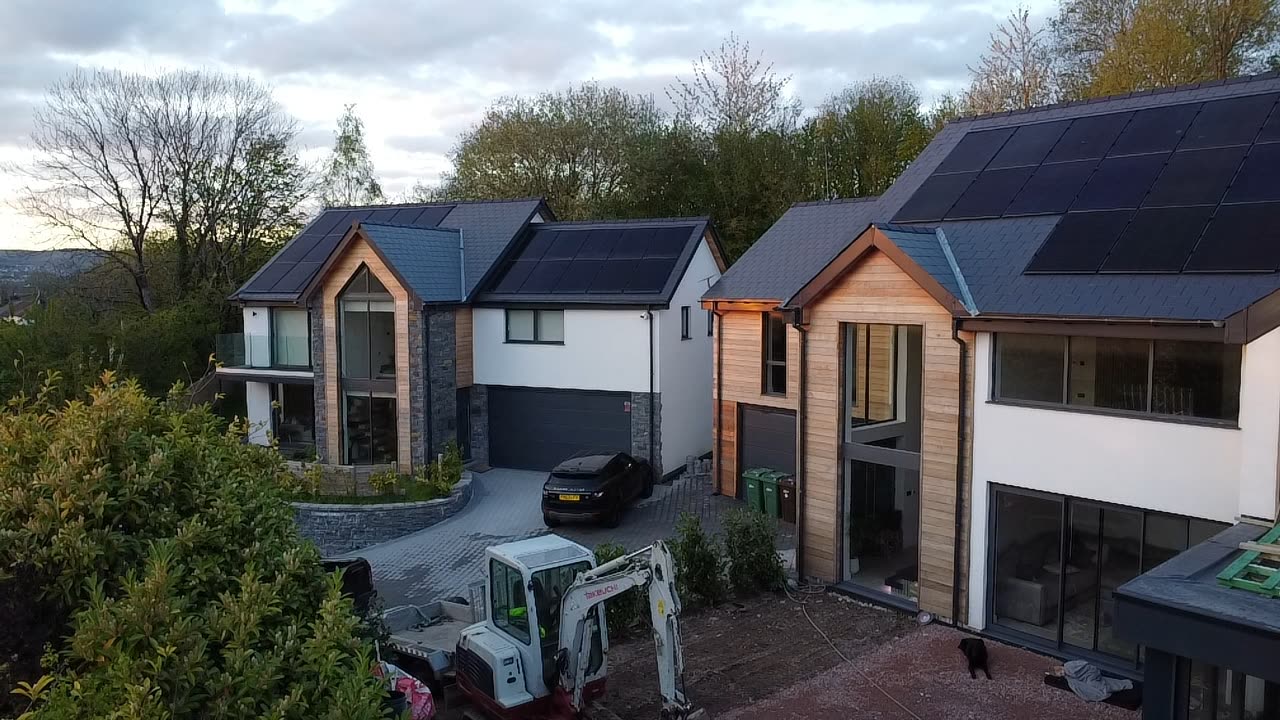 Aerial view of completed contemporary homes with landscaped gardens